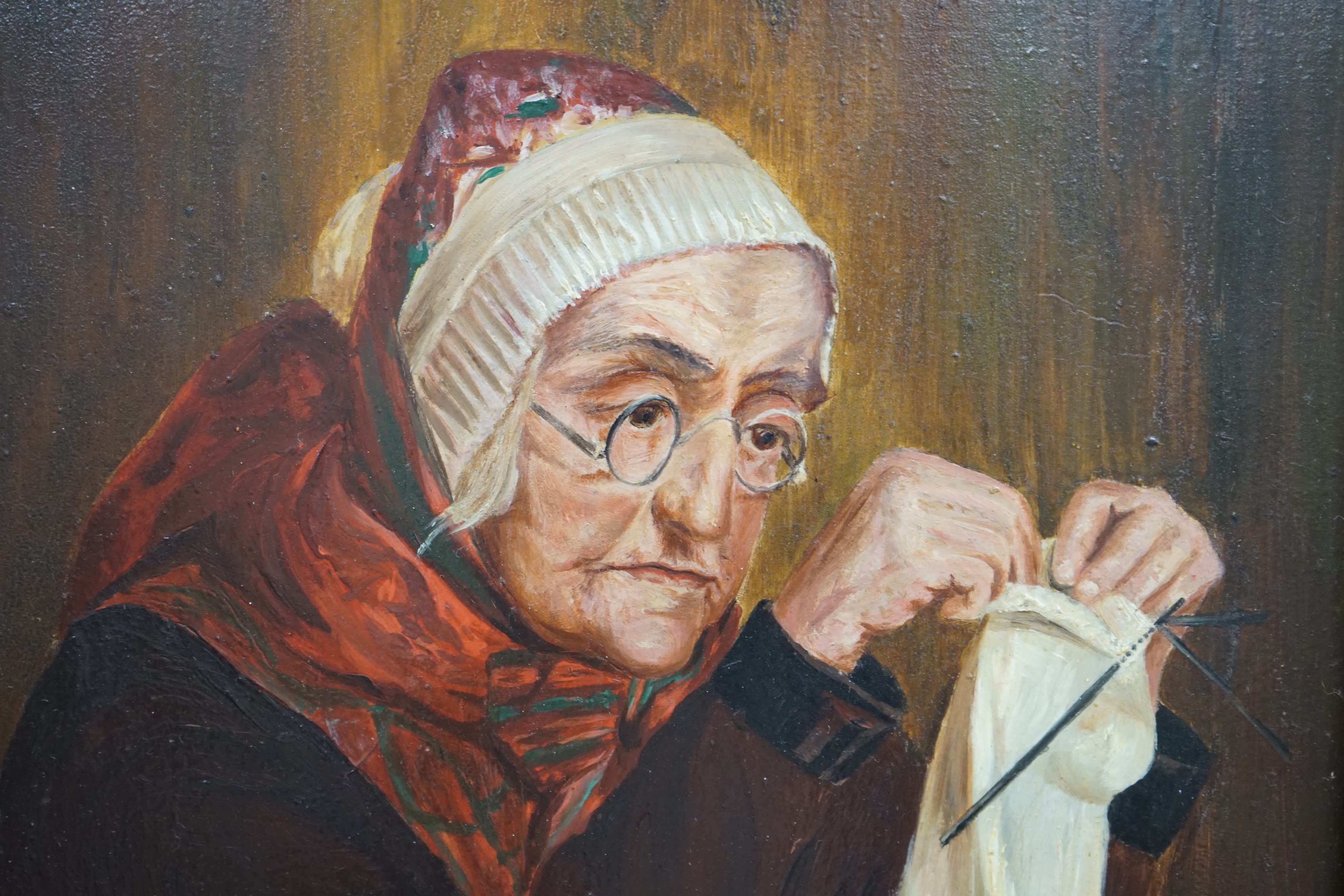 Early 20th century, oil on board, Portrait of an elderly lady sewing, 28 x 21cm, ornate gilt framed